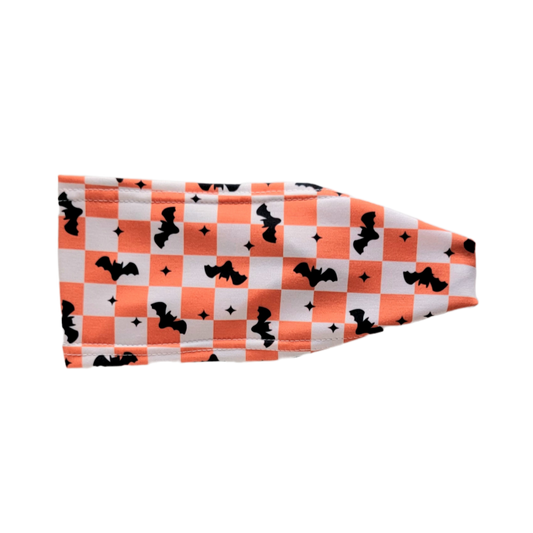 Headband with orange and white squares and blck bats