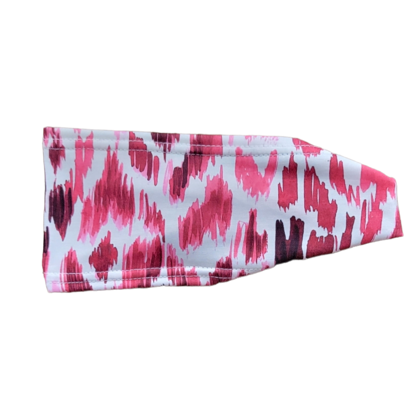 headband with red and pink abstract design on white