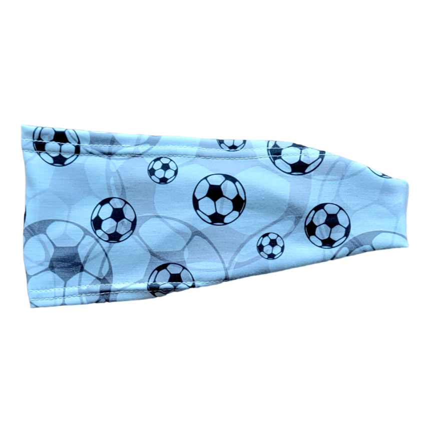 black soccer balls on grey