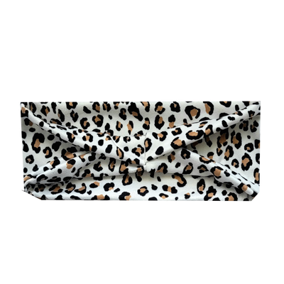 headband with small black and tan animal print spots on white