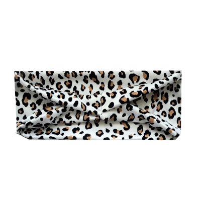 headband with small black and tan animal print spots on white