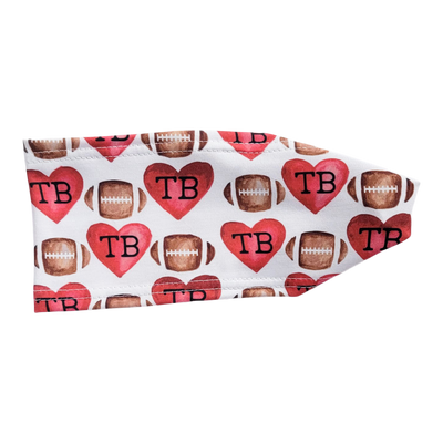 white headband with red hearts and brown footballs